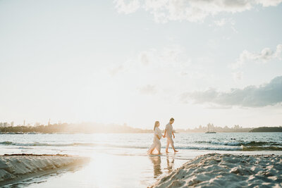 Expecting parents to be strolling around the water during sunset 