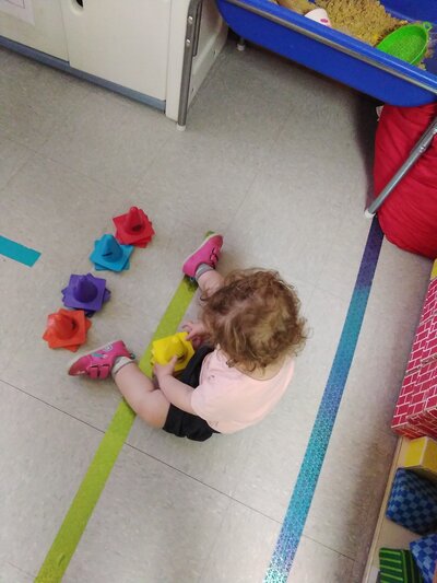 Toddler Girl Playing with Toys CPC Albuquerque Daycare