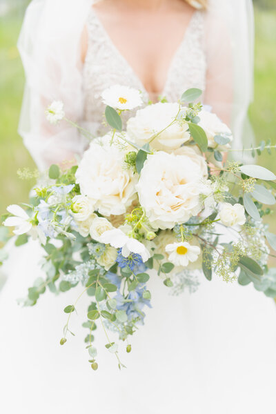 Bride holding her flower bouquet on wedding day