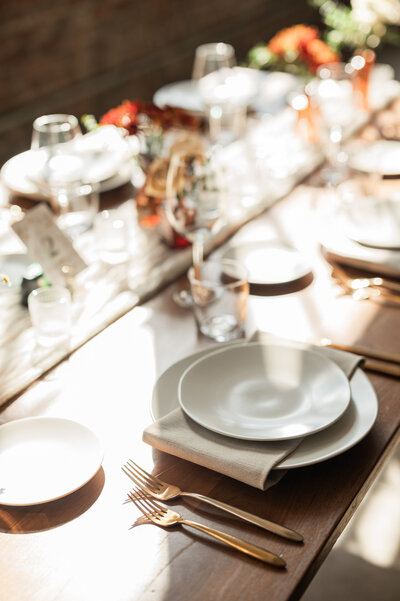 Flatware laid out on a wedding reception table with simple decorations