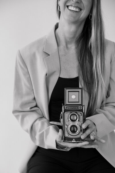 Wedding and Elopement Photographer, Emily Choy headshot with camera