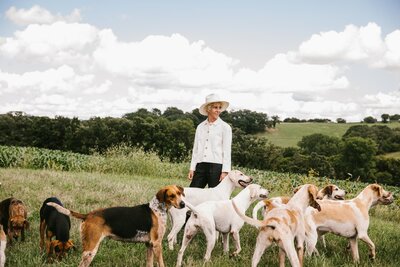 Sasha leading group of dogs on walk on the farm