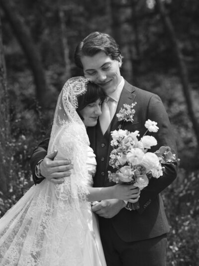 bride and groom in forest with waterfall