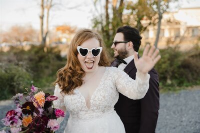 Bride wearing heart shaped glasses on her wedding day