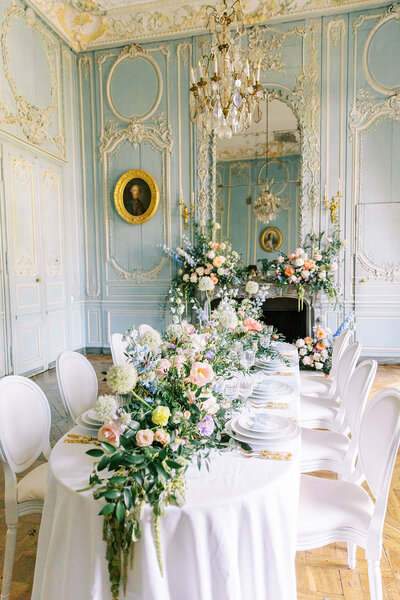 A bride cradles her bouquet of peonies in an etherial photograph by Beth Sheridan wedding photography.