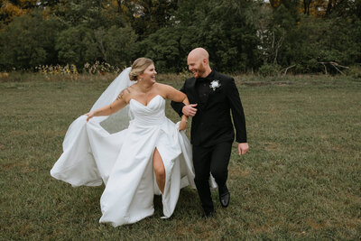 Groom spinning bride in wedding dress taken by fargo wedding photographer kiella lawrence