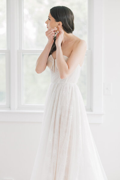South Carolina Wedding Photographer bride putting in earrings