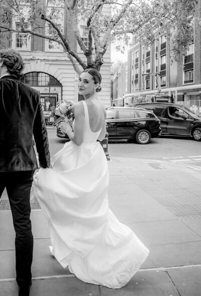 Micro wedding photography in London of bride drinking cocktail