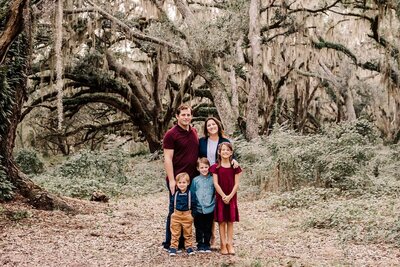 Family in large oak trees at Lake Runnymede in St. Cloud, FL