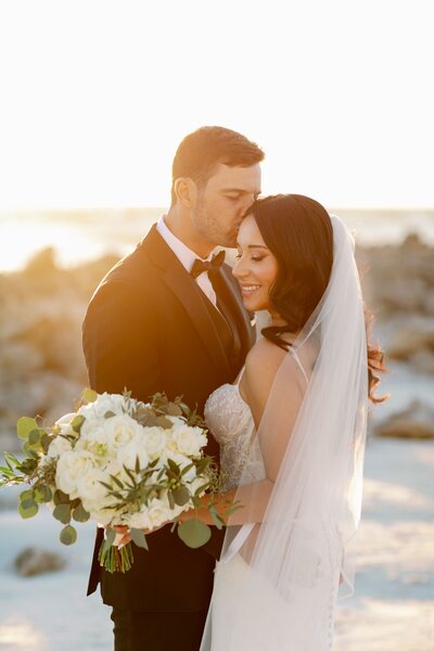 bride and groom pose at clearwater opal sands, fl