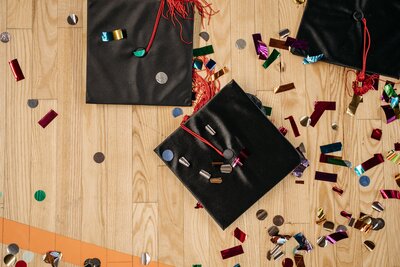 Stock image of graduation caps and confetti