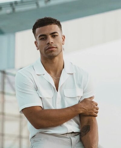 Light-skin male model with clean-cut beard poses outside