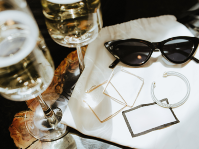 Champagne and sunglasses on a bar table