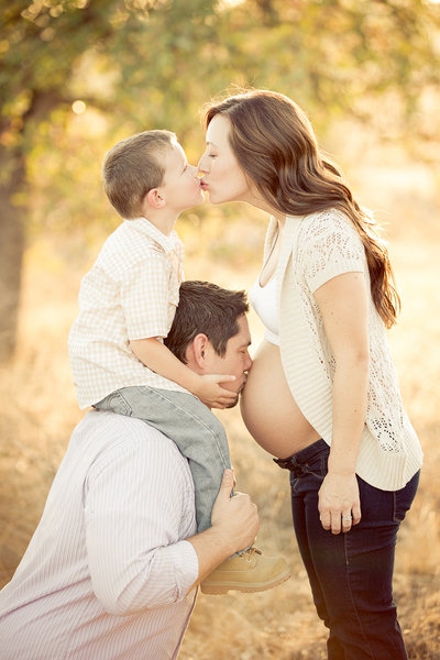 Three way kiss during Maternity Session in San Diego.