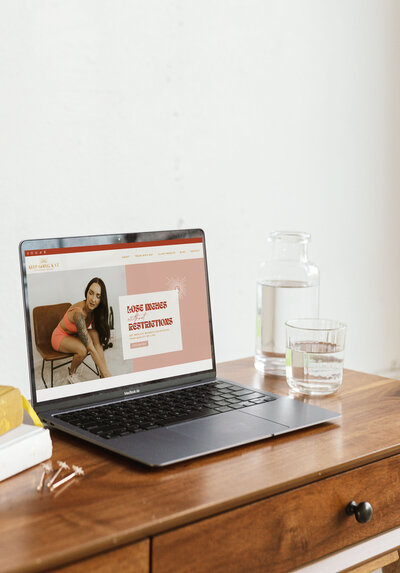 Custom Showit website for a personal trainer shown on a laptop