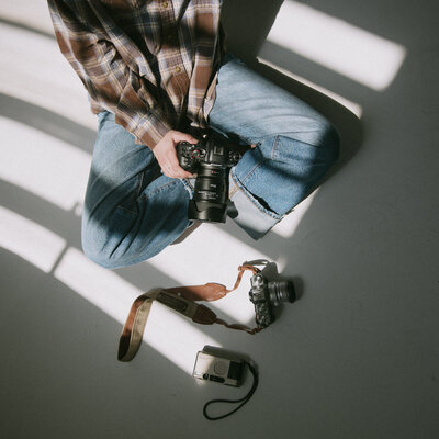 Green camera bag hanging in boise photographers' home office