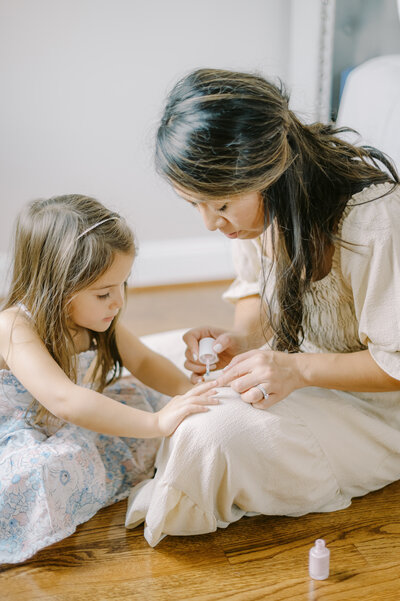 mother and daughter painting nails