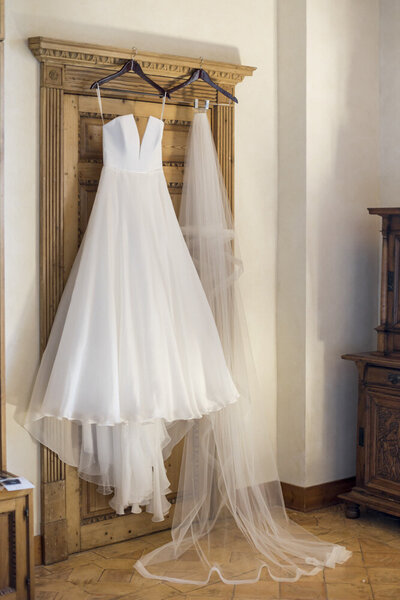 a wedding dress hanging in the bridal suite