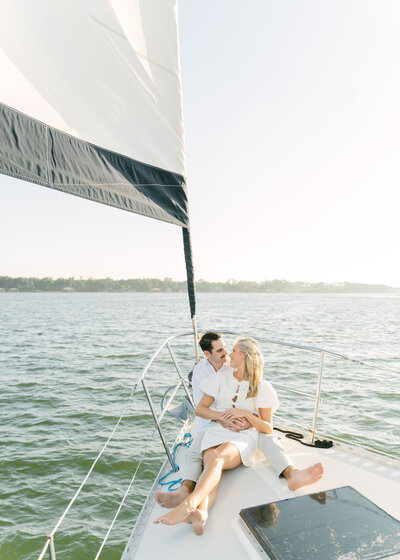 couple about to kiss on a sailboat