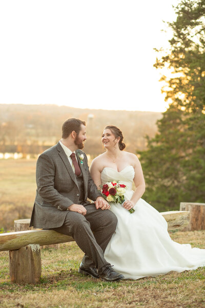 Groom is smiling while looking at his bride at Historic Tuckahoe in Richmond, Virginia.