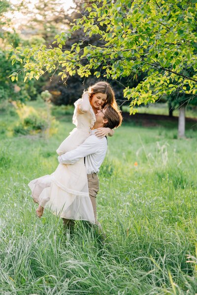 Couple shares a romantic embrace beside Lake Coeur d’Alene in Idaho during their wedding portrait session