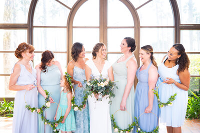 bride with bridesmaids in blue pastel toned dresses