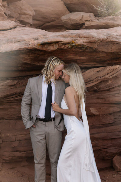 Couple in front of red rocks taken by Utah elopement photographer specializing in Moab weddings.