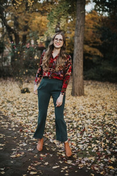 Woman standing on street with fall foliage