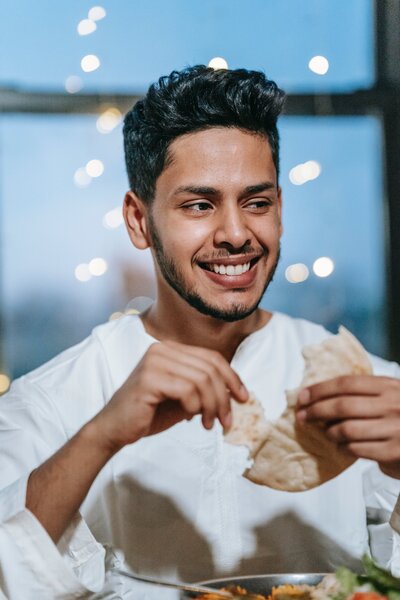 Man smiling while eating