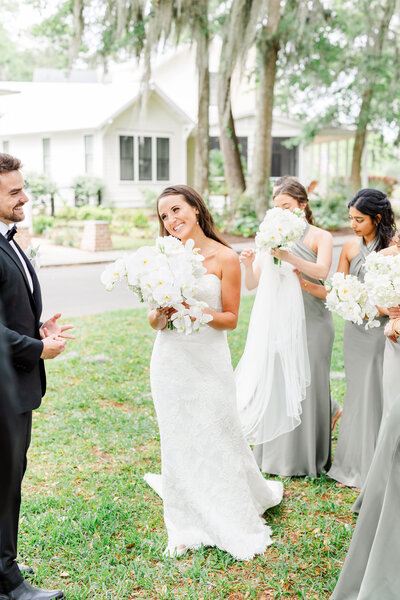 candid black and white photo of bride & groom entering their reception
