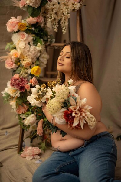 Snapzbytie Photography - Los Angeles Luxury Maternity Photographer - Mom wearing popular floral top but Vogue Styled with a floral ladder
