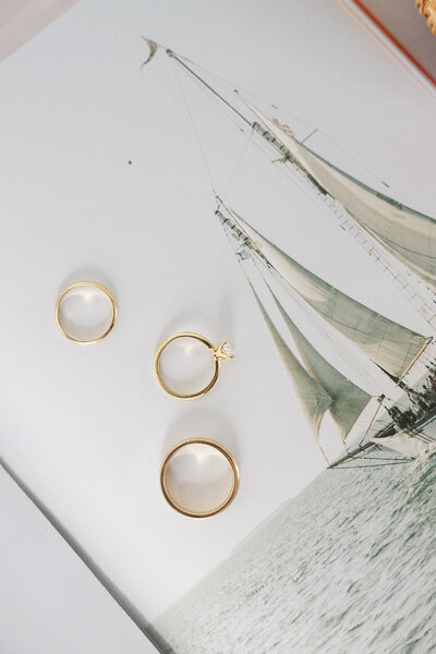 Three rings flatlay on a sailing book.