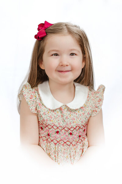 little girl in smocked dress during heirloom session by york pa photograper