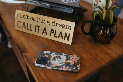 Woman writing in her notebook and planning for content writing clients | The Comma Mama Co