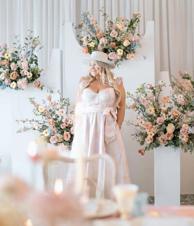 Owner of luxury event rentals serving GTA standing against a beautiful floral backdrop