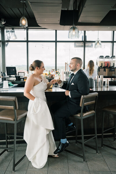 Bride and groom share a drink at the Bristol Hotel rooftop bar before their Bristol Train Station wedding