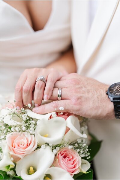 wedding rings and bouqet