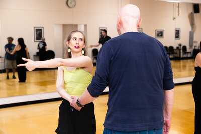 Couple taking a ballroom dance lesson.