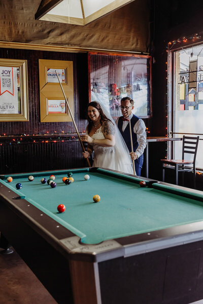couple playing pool during their florida elopement in downtown tampa 