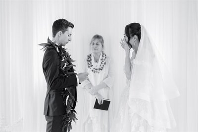 A couple standing up and saying their vows during their wedding ceremony 