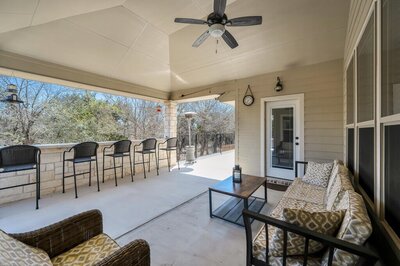 Deck and bar height seating for four at this three-bedroom, two-bathroom vacation rental lake house that sleeps eight just steps away from Stillhouse Hollow Lake in Belton, TX.