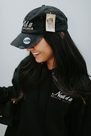 smiling woman holding an ice cream on one hand and a mobile phone on the other