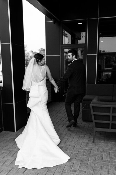 bride and groom leaving their ceremony at Port 393 in Holland Michigan wedding photographer