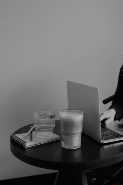 Brand Identity Express: Open laptop on table with coffee and notepad