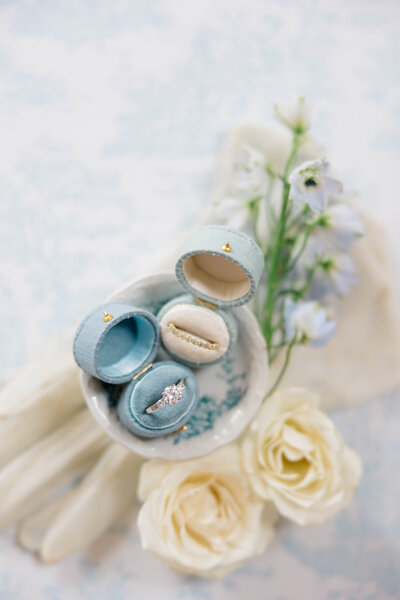 Two vintage blue and light blue ring boxes with rings with florals