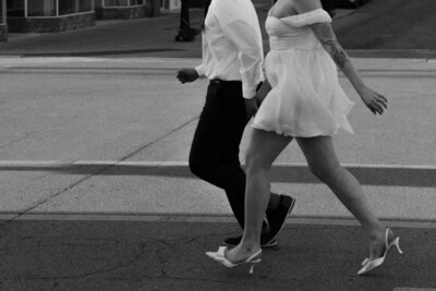 black and white image of couple walking at their elopement