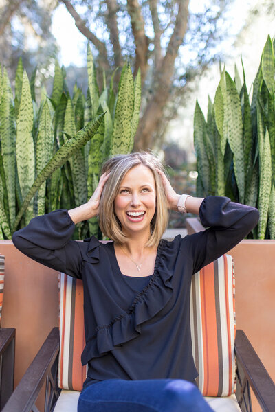 Headshot of Amanda Miller ruffling her hair.