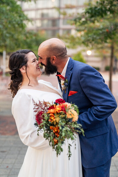 bride and groom smiling and laughing in downtown Durham