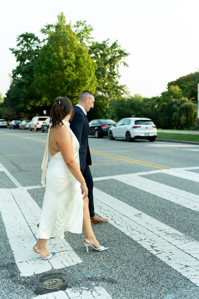couple crossing the street during editorial engagement session at the Cleveland museum of art