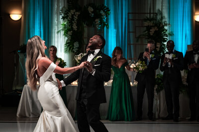bride and groom kissing on bar stools at Canoe Restaurant